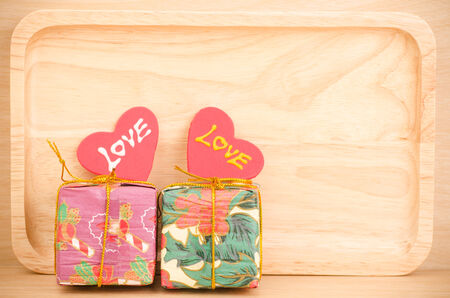 Gift box with love on wooden backgroundの写真素材