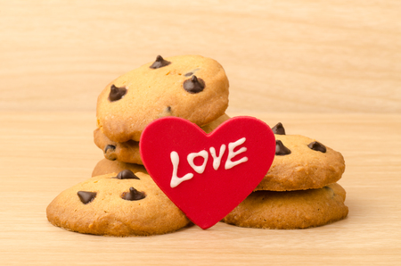 Chocolate chip cookies with love on wooden background in Valentine dayの写真素材
