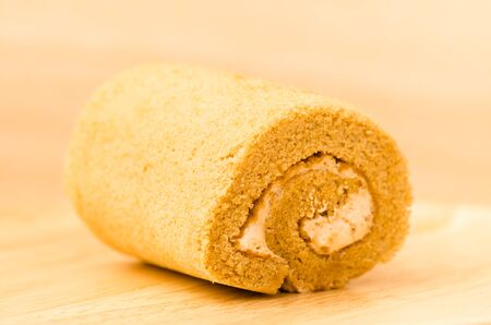 Roll cake on wooden backgroundの写真素材