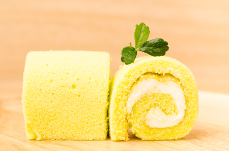 Roll cake on wooden backgroundの写真素材