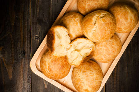 Homemade buns on wooden plate and wooden backgroundの写真素材