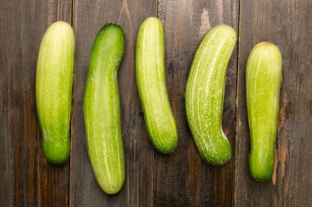 Fresh cucumber on wooden backgroundの写真素材