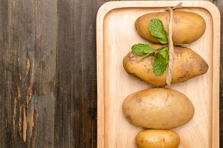 Raw potatoes on wooden background, Clean eatingの写真素材
