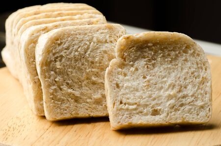 Close up of whole wheat bread on wooden plate