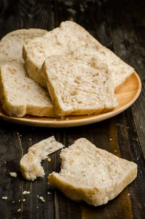Whole wheat bread on wooden background