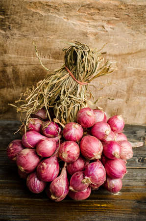 Raw shallot on wooden background,food ingredientの写真素材