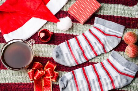 Christmas decoration,sock,red hat,ribbon,ball and giftbox on red background