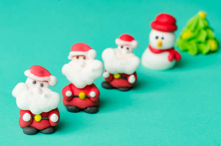 Christmas decoration, santa claus and snowman doll on green backgroundの写真素材