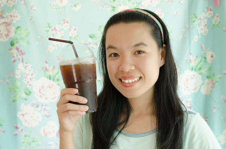 Portrait of asian woman drink ice coffee in the coffee shopの写真素材