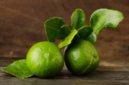 Raw lime on wooden backgroundの写真素材
