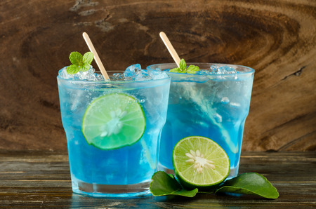 Ice blue drink with lemon on wooden backgroundの写真素材