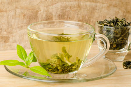The cup of hot green tea (Healthy drink) on wooden backgroundの写真素材