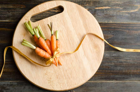 Fresh carrots with ribbon for givingの写真素材
