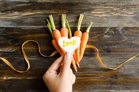 Fresh carrots with love for givingの写真素材