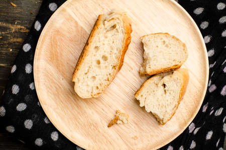 Slice of  bread on wooden plateの写真素材