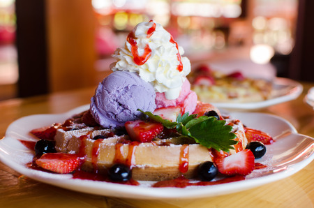 Waffle with ice cream,grape,strawberry and strawberry sauce