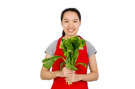 Happy woman holding green lettuce ready to cooking,isolated on white backgroundの写真素材