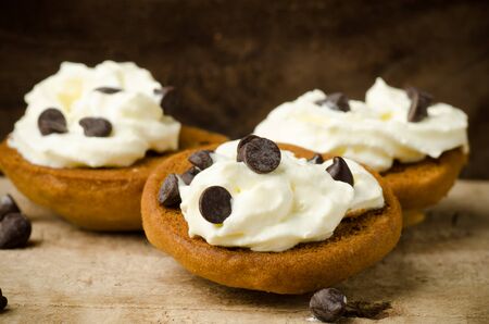 Homemade cookies with whipping cream and chocolate chip on topの写真素材