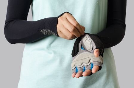 Woman wearing bicycle glove ready to cyclingの写真素材