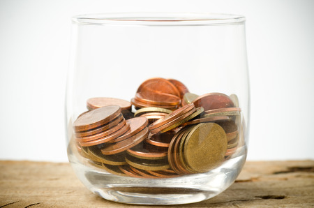 Heap of coins in glass,saving money conceptの写真素材