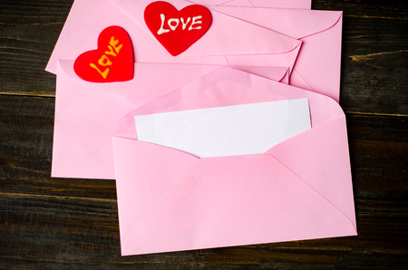 Pink envelope with blank white card and love heartの写真素材
