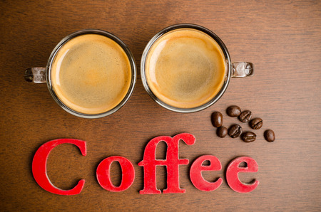 Two cups of hot coffee on wooden tableの写真素材