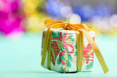 Decorative christmas gift box and ribbon on bokeh backgroundの写真素材