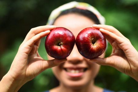 The woman holding fresh apple fruitの写真素材