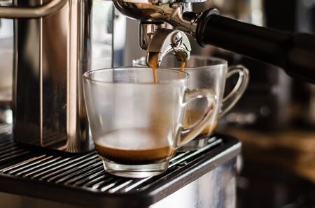The process of making coffee from esprsso machine in cafeの写真素材