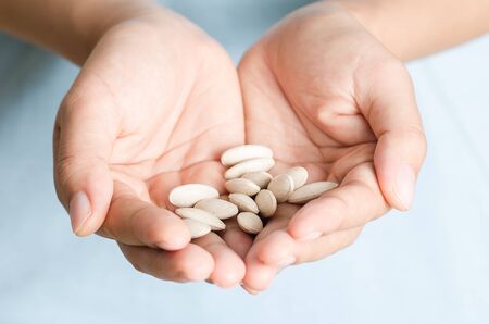 Medicine herb in hand,Alternative Medicine,Herbal supplement pill,eating healthyの写真素材