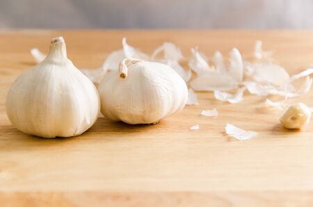 Fresh garlic and peel on wooden,food ingredientの写真素材