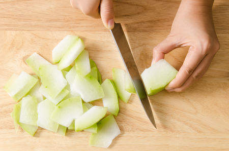 Chef cutting wax gourd on wooden board prepare for cooking Thai foodの写真素材