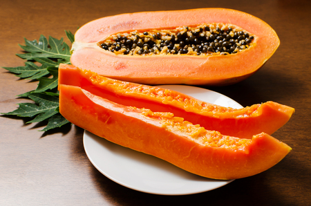 Ripe papaya fruit on wooden gackground ready to eatingの写真素材