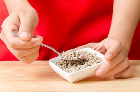 Spoon of white pepper seed for cooking,spices and herb