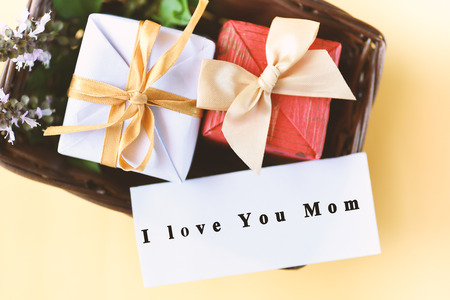 Gift box in basket with I love you mom text on card,Mother's day conceptの写真素材