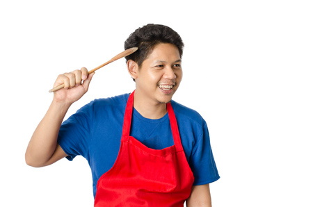 Asian man ready to cooking isolated on white backgroundの写真素材