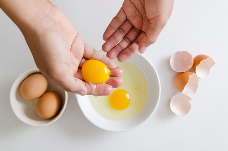 Egg yolk separate on the hand for cooking,food ingredientの写真素材