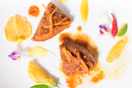 Northern Thai food (Kaeng Hang Le),spicy curry pork mixed with spices and decorated with flower.Top...