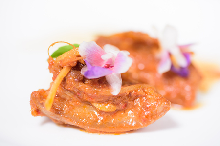 Northern Thai food (Kaeng Hang Le),spicy curry pork mixed with spices and decorated with flowerの写真素材