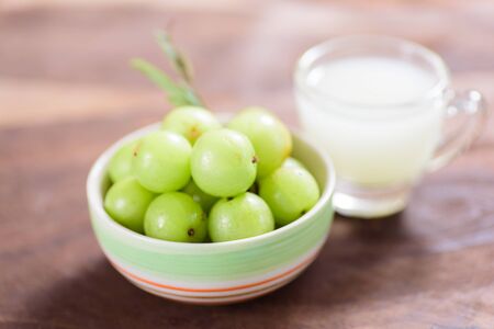 Indian gooseberry fruit and juice on wooden background,healthy foodの写真素材