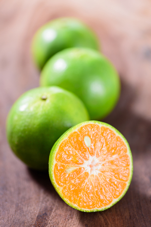 Green tangerine orange fruit on wooden background, healthy fruitの写真素材