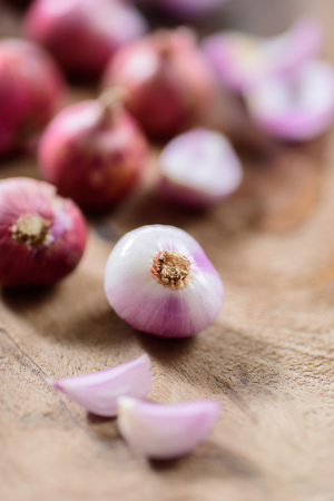 Slice shallots on wooden background for cooking,spice an herb,food ingredientの写真素材