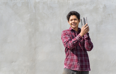 Asian builder man holding concrete blocks for house buildingの写真素材
