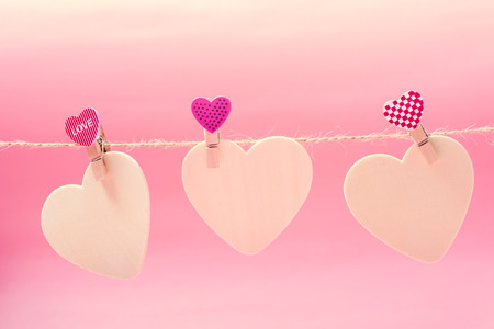 White hearts with clothes pegs hanging on string, Valentine conceptの写真素材