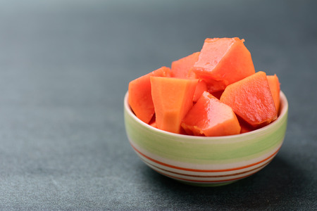 Piece of ripe papaya in a bowl, tropical fruitの写真素材