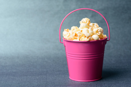 Caramel popcorn in a pink bucketの写真素材