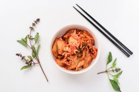 Kimchi cabbage (Korean food) in a bowl with chopsticks, top viewの写真素材