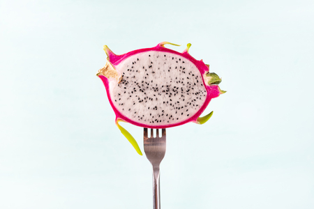 Slice dragon fruit on fork for eating, tropical fruitの写真素材