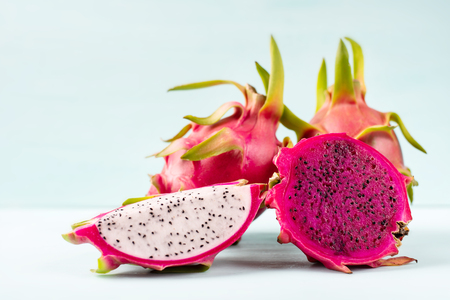 Half and slice dragon fruit on color background, tropical fruitの写真素材