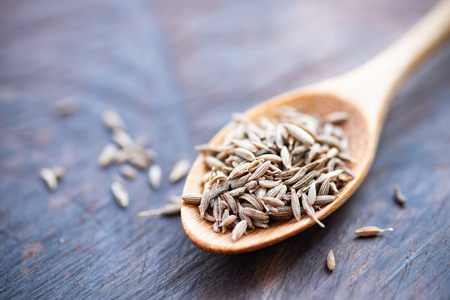 Caraway seeds on wooden spoon, herb and spice, food ingredientの写真素材